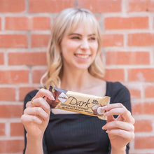 Load image into Gallery viewer, Woman in front of a brick wall holding a Chocolate Coconut bar
